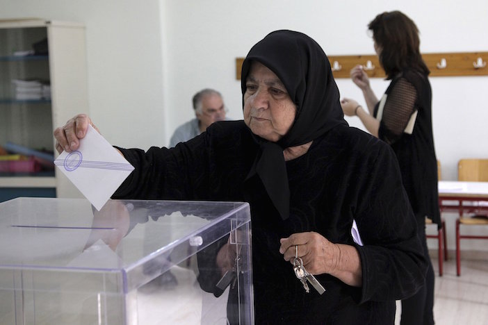 A woman wearing her traditional black-- said to be worn by the people of Anogeia in perpetuity for the burning of their village during World War II